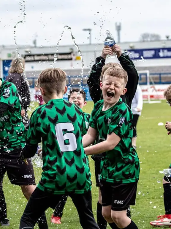 Football kit designer | Players Celebrating | Design it. Wear it. Custom football kits delivered by SWAZ.